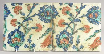 A PAIR OF FINE EARLY 17TH CENTURY TURKISH OTTOMAN IZNIK GLAZED POTTERY TILES, painted with red,