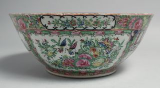 A CHINESE CANTON FAMILLE ROSE PORCELAIN BOWL, painted with panels of figures, birds and native