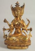 A GILT BRONZE FIGURE OF A THREE-HEADED MULTI-ARM DEITY, 27cm high.