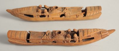 A PAIR OF CHINESE CARVED WOOD BOATS, 28cm long.