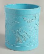 A CHINESE BLUE GLAZED PORCELAIN BRUSH POT, with relief decoration depicting cranes in a landscape
