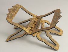 AN ISLAMIC GOLD INLAID STEEL FOLDING QURAN STAND, with bands of calligraphy, 31cm wide (when