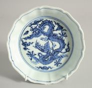 A CHINESE BLUE AND WHITE PORCELAIN PETAL FORM BOWL, the interior centre with dragon, the exterior