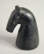 AN EARLY ISLAMIC JET GAMING PIECE, 6.5cm.