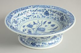 A CHINESE BLUE AND WHITE PORCELAIN FOOTED DISH, painted all over with lotus and scrolling vine,