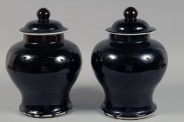 A PAIR OF CHINESE DARK BROWN GLAZE JARS AND COVERS. 30cm high overall.