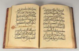A LARGE NORTH AFRICAN LEATHER-BOUND QURAN, 39cm x 30cm.