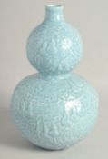 A CHINESE POWDER BLUE GLAZE DOUBLE GOURD VASE, with raised decoration all over depicting gourds