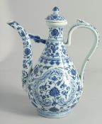 A LARGE CHINESE MING STYLE BLUE AND WHITE PORCELAIN LIDDED WINE EWER, painted with swirling vine and