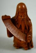 A SMALL JAPANESE CARVED WOOD FIGURE of a sage holding a scroll, 6cm high.
