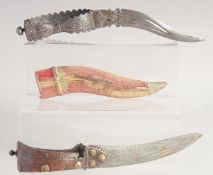 TWO 18TH CENTURY SOUTH INDIAN BICHWA DAGGERS, one with silver inlaid handle and clothed wooden