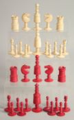 A COLLECTION OF CARVED AND STAINED BONE CHESS PIECES.