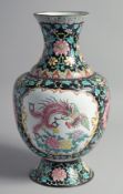 A LARGE CHINESE BLACK GROUND ENAMELLED VASE, painted with two panels; one depicting an exotic
