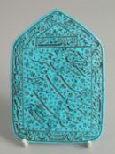 AN ISLAMIC INSCRIBED TURQUOISE STONE MIHRAB, 12cm x 8.5cm.