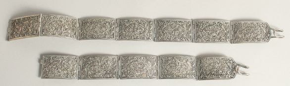 AN INDIAN ENGRAVED WHITE METAL BELT.