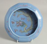 A CHINESE POWDER BLUE PORCELAIN BRUSH WASH, the interior centre painted with a dragon and stylised