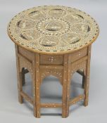 A GOOD AND UNUSUAL INDIAN BONE INLAID CIRCULAR HARDWOOD TABLE, with folding base, the top inlaid