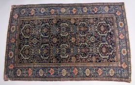 A PERSIAN FARHAN RUG, with dark blue ground and decorated with animal and floral motifs in a foliate