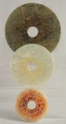 THREE CHINESE CARVED JADE BI DISKS, 17cm, 13cm and 9cm, (3).