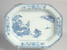 A CHINESE BLUE AND WHITE PORCELAIN SERVING DISH, painted with a landscape view over water with a
