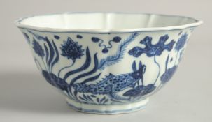A CHINESE BLUE AND WHITE PORCELAIN PETAL FORMED BOWL, painted with fish and algae, the base with