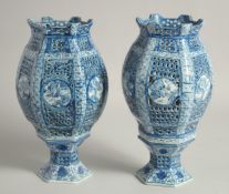 A PAIR OF CHINESE BLUE AND WHITE PORCELAIN HEXAGONAL LAMPS, with pierced panels and bases, 26.5cm