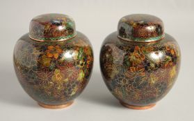 A GOOD PAIR OF CHINESE CLOISONNE JARS AND COVERS, finely decorated with various coloured enamel