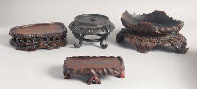 FOUR CHINESE CARVED HARDWOOD STANDS, various sizes, (4).