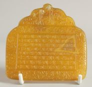 A FINE ISLAMIC YELLOW AGATE INSCRIBED TABLET, with very finely engraved calligraphy, 8.5cm x 8.5cm.