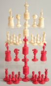 A COLLECTION OF CARVED AND STAINED BONE CHESS PIECES.