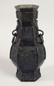 A CHINESE BRONZE HEXAGONAL FORMED VASE with drop ring handles and engraved archaic design to the