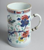 A CHINESE FAMILLE ROSE PORCELAIN TANKARD painted with floral sprays and exotic bird. 14.5cm high
