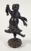 A CHINESE BRONZE FIGURE OF A DANCING MAN, mounted to a lotus-formed base, possibly Ming. 15cm high.