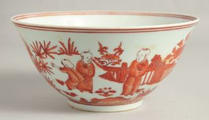 A CHINESE IRON RED AND WHITE PORCELAIN BOWL, the exterior painted with many figures in a garden