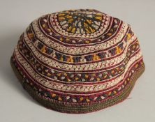 AN UZBEK SUZANI EMBROIDERED SKULL CAP.