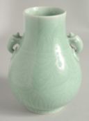 A CHINESE CLAIRE-DE-LUNE CELADON GLAZE TWIN HANDLE VASE, of archaic form with moulded handles and