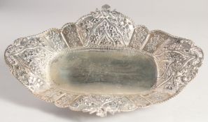 A SILVER LOZENGE SHAPED DISH, with embossed and pierced border, flower head motifs on four curving