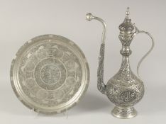 A LARGE TURKISH ENGRAVED METAL EWER, 51cm high, together with a similar circular dish, 38cm