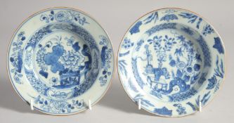 TWO SIMILAR CHINESE BLUE AND WHITE PORCELAIN SHALLOW BOWLS, one painted with flowers against a