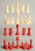 A COLLECTION OF CARVED AND STAINED BONE CHESS PIECES.