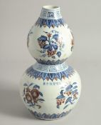 A CHINESE BLUE, WHITE, AND UNDERGLAZE RED PORCELAIN DOUBLE GOURD VASE, painted with various