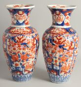A LARGE PAIR OF JAPANESE IMARI PORCELAIN VASES, each with ribbed body and painted with flora, 37.5cm