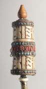 AN UNUSUAL 19TH CENTURY TIBETAN CARVED BONE PRAYING WHEEL. 24.5cm long