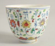 A CHINESE DOUCAI PORCELAIN CUP, painted with floral motifs and characters, the base with six-