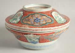 A JAPANESE ARITA PORCELAIN CIRCULAR LIDDED TUREEN, painted with panels of birds and flora, 26.5cm