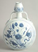 A CHINESE BLUE AND WHITE PORCELAIN TWIN HANDLED MOON FLASK, the centre painted with floral spray.