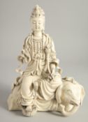A DEHUA PORCELAIN GUANYIN FIGURE, seated upon an elephant, the reverse with impressed marks. 32cm