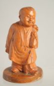 A SMALL CHINESE REPUBLICAN CARVED BOXWOOD FIGURE of a boy, 9.5cm high.
