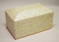 A LARGE INDIAN MOTHER OF PEARL VENEERED SARCOPHAGUS SHAPED COFFER, the hinged cover revealing a