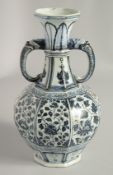 A CHINESE BLUE AND WHITE PORCELAIN TWIN HANDLE VASE, the handles moulded as elephant-like beasts,